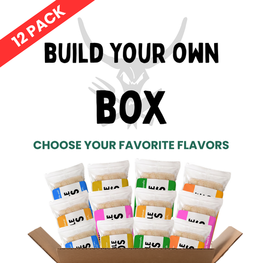 A promotional graphic for a 12-pack box of snacks or supplements. The text reads 'BUILD YOUR OWN BOX' and 'CHOOSE YOUR FAVORITE FLAVORS' with a red '12 PACK' banner in the top-left corner.