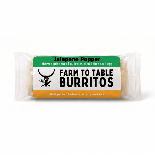A packaged burrito in a clear plastic wrapper with a green, white, and orange label reading 'Jalapeno Popper' and 'Farm To Table Burritos' on a white background.