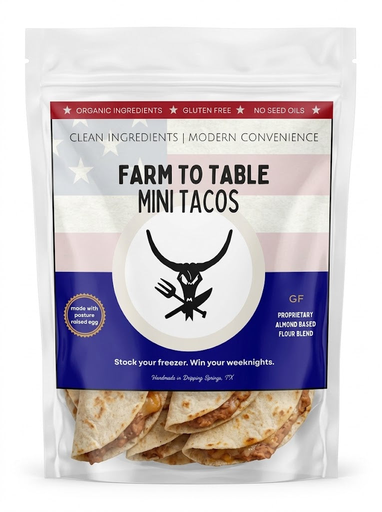 A stand-up pouch of Farm to Table Mini Tacos on a plain white background. The package is mostly clear plastic showing the tacos inside, with a large front label featuring red, white, and blue sections, a black horned logo, and text including 'FARM TO TABLE MINI TACOS', 'ORGANIC INGREDIENTS', 'GLUTEN FREE', and 'NO SEED OILS'.
